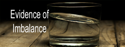 A glass of water leaning unbalanced
