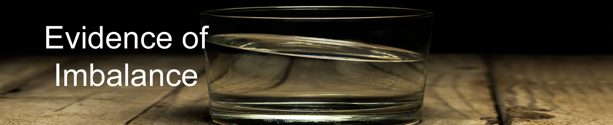 Glass of water leaning over with imbalance